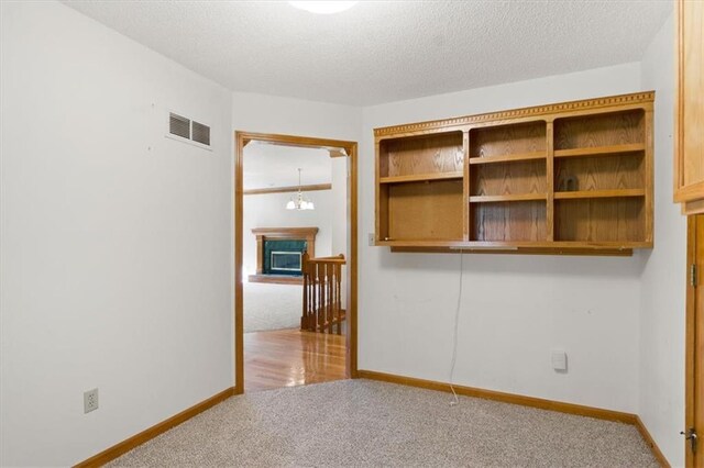 3000 Cedar Crest Dr, Independence, MO 64057 - spare room featuring carpet, baseboards, and a textured ceiling