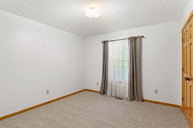 3000 Cedar Crest Dr, Independence, MO 64057 - unfurnished room featuring light colored carpet, a textured ceiling, and baseboards