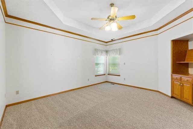 3000 Cedar Crest Dr, Independence, MO 64057 - empty room with light colored carpet, a tray ceiling, baseboards, and crown molding
