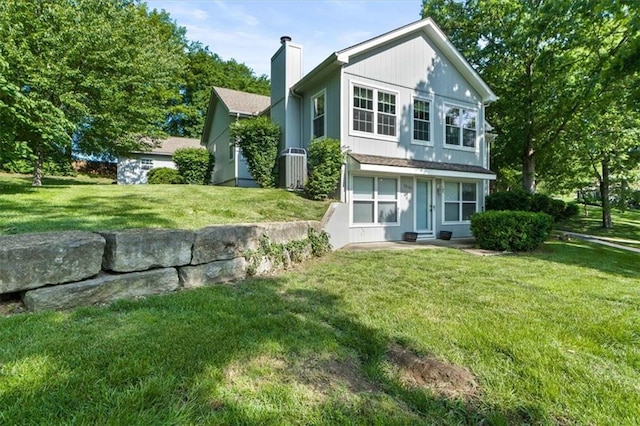 3000 Cedar Crest Dr, Independence, MO 64057 - back of property featuring a chimney and a lawn