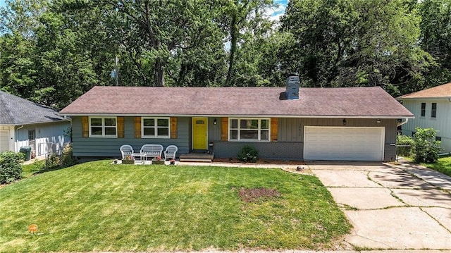 10621 E 32nd St, Independence, MO 64052 - view of front of home with a chimney, driveway, a front yard, and an attached garage