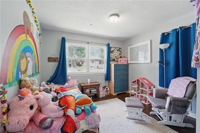 10621 E 32nd St, Independence, MO 64052 - bedroom featuring a textured ceiling and wood finished floors