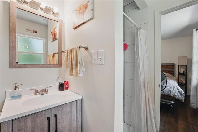10621 E 32nd St, Independence, MO 64052 - ensuite bathroom with vanity, wood finished floors, and curtained shower