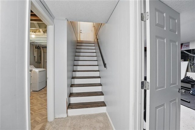 10621 E 32nd St, Independence, MO 64052 - staircase with washing machine and dryer and a textured ceiling