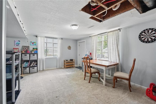 10621 E 32nd St, Independence, MO 64052 - dining space with baseboards, a textured ceiling, and carpet floors