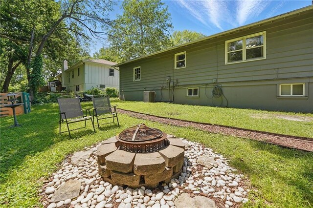 10621 E 32nd St, Independence, MO 64052 - view of green lawn with an outdoor fire pit and central air condition unit