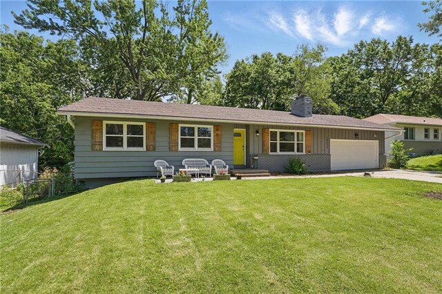 10621 E 32nd St, Independence, MO 64052 - single story home featuring board and batten siding, concrete driveway, a chimney, and an attached garage