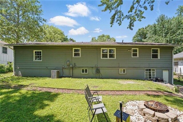 10621 E 32nd St, Independence, MO 64052 - rear view of property featuring an outdoor fire pit, a yard, and central air condition unit