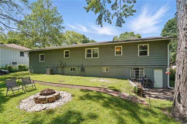 10621 E 32nd St, Independence, MO 64052 - back of property with an outdoor fire pit, a lawn, and central air condition unit