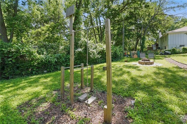 10621 E 32nd St, Independence, MO 64052 - view of green lawn featuring an outdoor fire pit