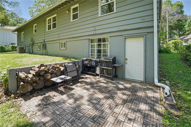 10621 E 32nd St, Independence, MO 64052 - back of property with a patio area, central AC, and a lawn