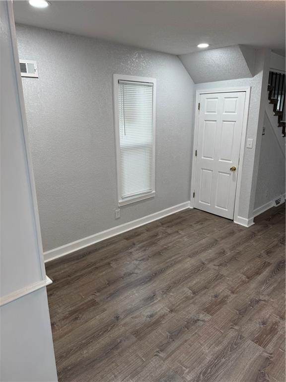 116 N Home St, Independence, MO 64053 - empty room featuring dark wood finished floors, stairs, baseboards, recessed lighting, and a textured wall