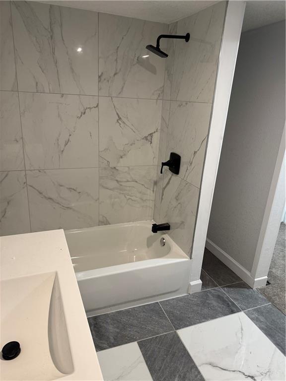 116 N Home St, Independence, MO 64053 - full bathroom with shower / washtub combination, marble finish floors, baseboards, and a sink