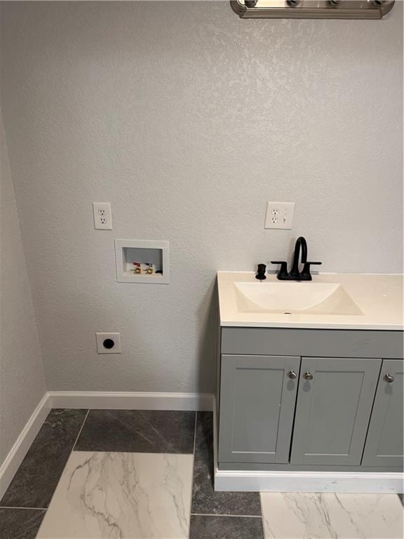 116 N Home St, Independence, MO 64053 - laundry room featuring washer hookup, electric dryer hookup, dark marble finish floors, and baseboards