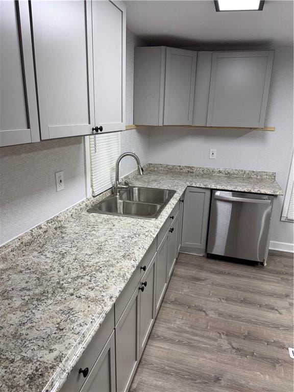 116 N Home St, Independence, MO 64053 - kitchen featuring dishwasher, gray cabinets, a sink, wood finished floors, and light stone counters