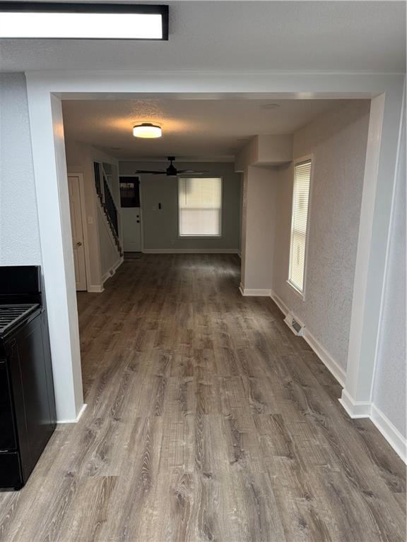 116 N Home St, Independence, MO 64053 - corridor featuring wood finished floors, stairs, and baseboards