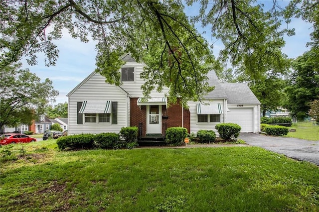 2738 S Crysler Ave, Independence, MO 64052 - view of front facade with an attached garage, asphalt driveway, a front yard, and brick siding