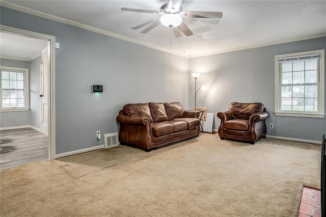 2738 S Crysler Ave, Independence, MO 64052 - living area featuring crown molding, carpet flooring, baseboards, and ceiling fan