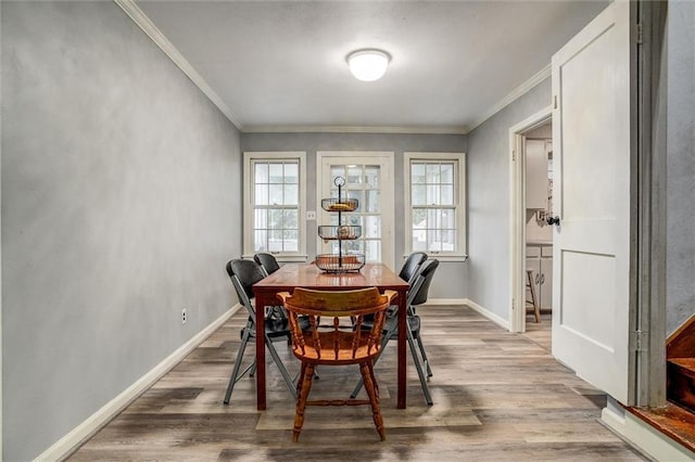 2738 S Crysler Ave, Independence, MO 64052 - dining area with healthy amount of natural light, wood finished floors, ornamental molding, and baseboards