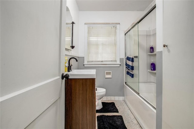 2738 S Crysler Ave, Independence, MO 64052 - bathroom with toilet, vanity, shower / bath combination with glass door, tile patterned floors, and baseboards