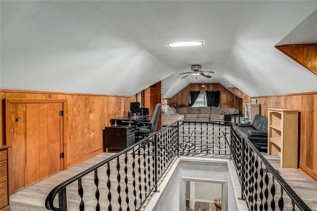 2738 S Crysler Ave, Independence, MO 64052 - additional living space with wooden walls, lofted ceiling, a ceiling fan, and light wood finished floors