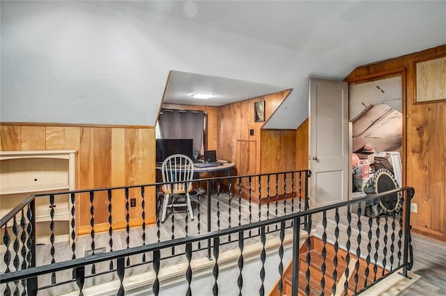 2738 S Crysler Ave, Independence, MO 64052 - corridor with wood walls, lofted ceiling, wood finished floors, and an upstairs landing