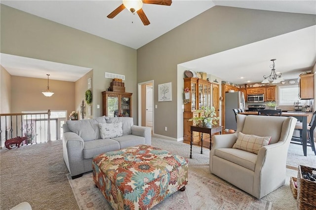 1037 NW 91st Ter, Kansas City, MO 64155 - living room with light colored carpet, high vaulted ceiling, a ceiling fan, baseboards, and a chandelier