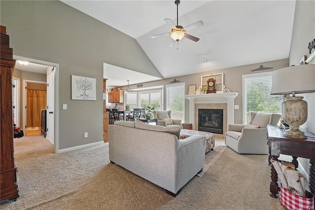 1037 NW 91st Ter, Kansas City, MO 64155 - living room with light colored carpet, ceiling fan, a glass covered fireplace, baseboards, and high vaulted ceiling