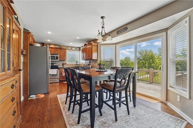 1037 NW 91st Ter, Kansas City, MO 64155 - dining area with a textured ceiling, wood finished floors, recessed lighting, and baseboards