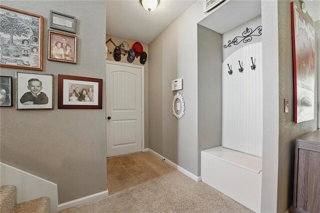 1037 NW 91st Ter, Kansas City, MO 64155 - mudroom featuring carpet flooring and baseboards
