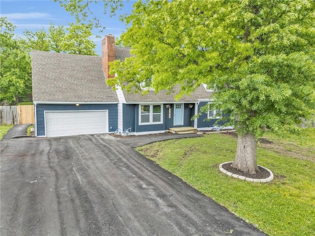 706 W Cedar St, Olathe, KS 66061 - view of front of property with an attached garage, asphalt driveway, a chimney, and roof with shingles