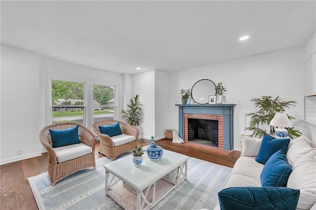 706 W Cedar St, Olathe, KS 66061 - living room featuring a brick fireplace, wood finished floors, recessed lighting, and baseboards