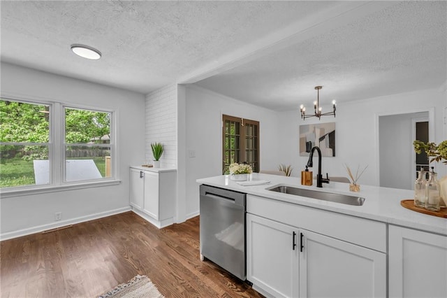 706 W Cedar St, Olathe, KS 66061 - kitchen featuring stainless steel dishwasher, a sink, a textured ceiling, light countertops, and white cabinetry