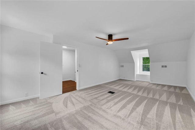 706 W Cedar St, Olathe, KS 66061 - additional living space with light carpet, ceiling fan, baseboards, and lofted ceiling