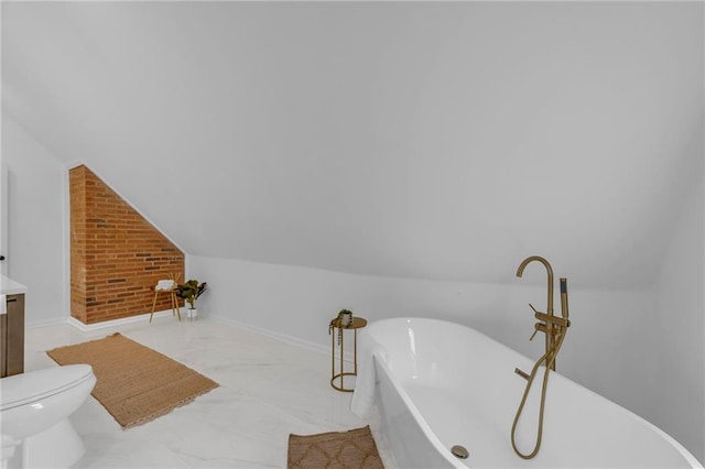 706 W Cedar St, Olathe, KS 66061 - bathroom with a soaking tub, lofted ceiling, vanity, toilet, and baseboards