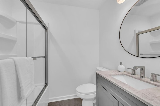 706 W Cedar St, Olathe, KS 66061 - full bathroom featuring vanity, toilet, tile patterned flooring, and baseboards