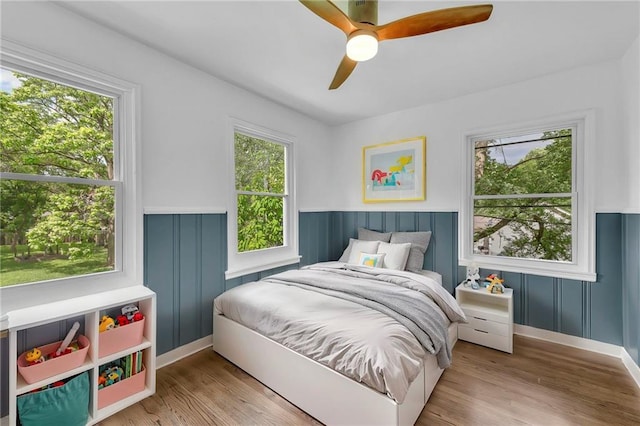 706 W Cedar St, Olathe, KS 66061 - bedroom with wainscoting, wood finished floors, and a ceiling fan