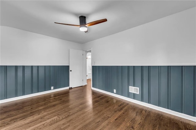706 W Cedar St, Olathe, KS 66061 - unfurnished room with wainscoting, ceiling fan, and wood finished floors