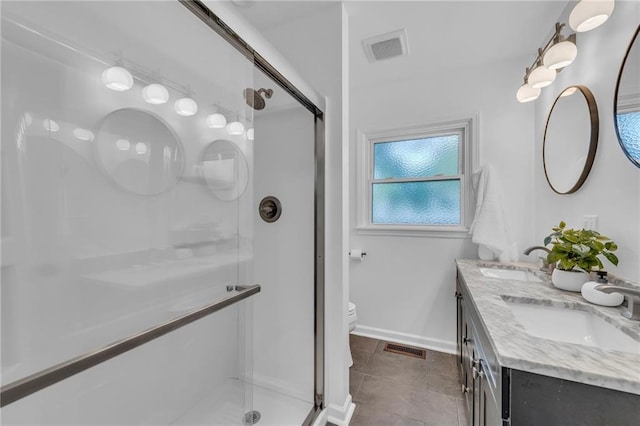 706 W Cedar St, Olathe, KS 66061 - bathroom with a shower stall, double vanity, baseboards, toilet, and tile patterned flooring