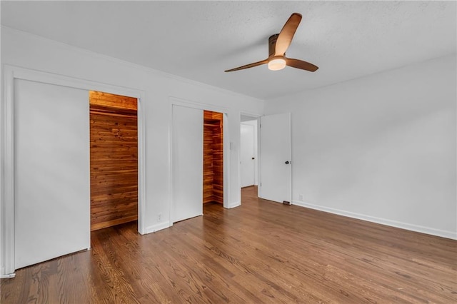 706 W Cedar St, Olathe, KS 66061 - unfurnished bedroom with wood finished floors, baseboards, and ceiling fan