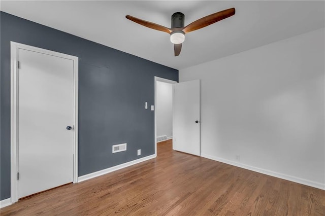 706 W Cedar St, Olathe, KS 66061 - spare room featuring wood finished floors, a ceiling fan, and baseboards