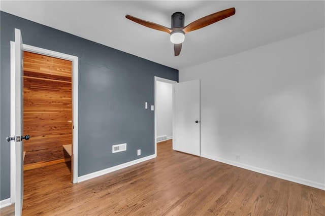706 W Cedar St, Olathe, KS 66061 - unfurnished bedroom with wood finished floors, baseboards, and a ceiling fan