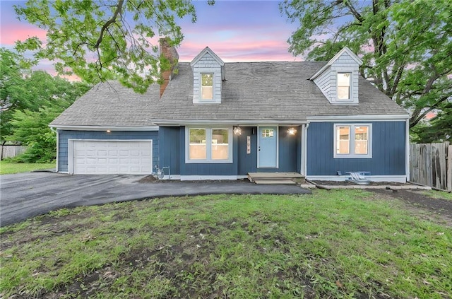 706 W Cedar St, Olathe, KS 66061 - cape cod home with a garage, asphalt driveway, and a chimney
