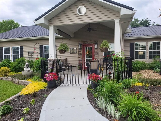 1154 SE 364p Rd, Clinton, MO 64735 - view of exterior entry featuring ceiling fan, a gate, and metal roof