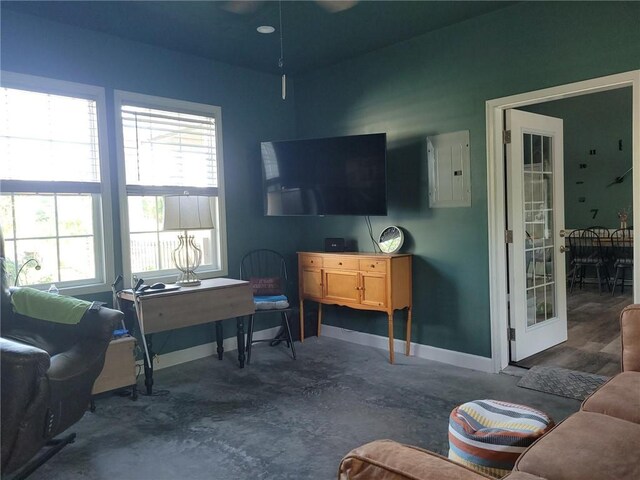 1154 SE 364p Rd, Clinton, MO 64735 - living room featuring electric panel, baseboards, and unfinished concrete floors