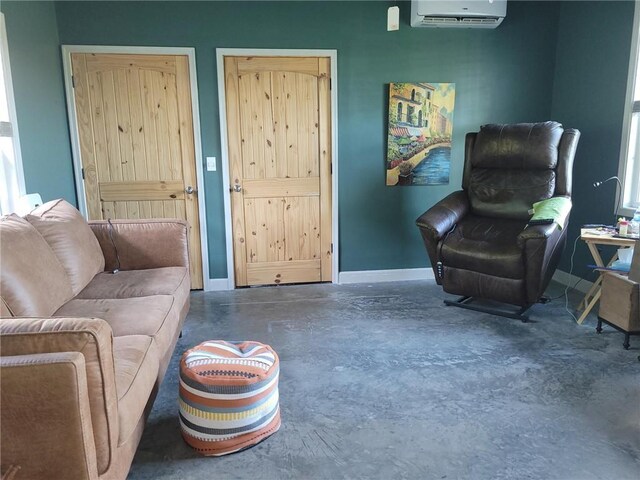1154 SE 364p Rd, Clinton, MO 64735 - living area featuring a wall mounted AC, finished concrete flooring, and baseboards