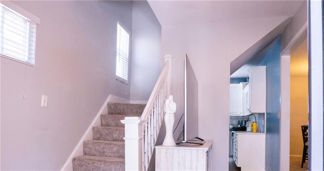 3812 Anderson Ave, Kansas City, MO 64132 - stairway with plenty of natural light and baseboards