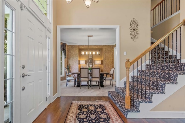15801 Parkhill St, Overland Park, KS 66221 - entryway featuring stairs, healthy amount of natural light, baseboards, wood finished floors, and crown molding