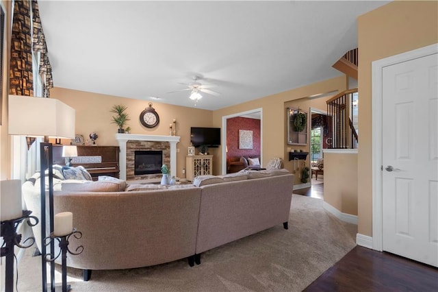 15801 Parkhill St, Overland Park, KS 66221 - living room featuring a stone fireplace, a ceiling fan, wood finished floors, and baseboards