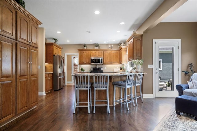 15801 Parkhill St, Overland Park, KS 66221 - kitchen with stainless steel appliances, dark wood-style flooring, baseboards, a peninsula, and recessed lighting